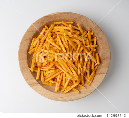 Fried chips sticks isolated, finger potato chips, golden shoestring fries pile, French fries Fried chips sticks isolated, finger potato chips, golden shoestring fries pile, French fries 142998542