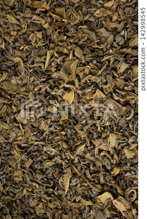 Green tea leaves macro textured background Green tea leaves macro textured background 142998545