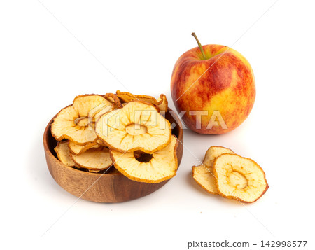 Dry apple slices isolated, dried apple chips, healthy fruit snack Dry apple slices isolated, dried apple chips, healthy fruit snack 142998577