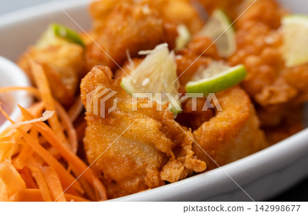 Crispy chicken popcorn with tomato sauce closeup Crispy chicken popcorn with tomato sauce closeup 142998677