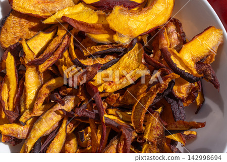 Dried nectarines and peaches in fruit dryer close up Dried nectarines and peaches in fruit dryer close up 142998694