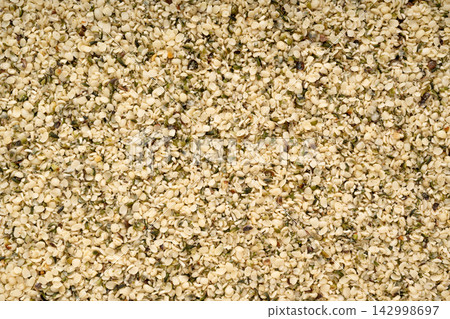Shelled hemp seeds texture background 142998697