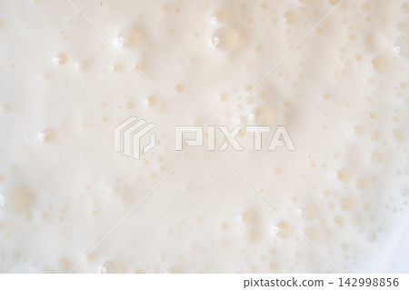Milkshake texture closeup, white milk shake Milkshake texture closeup, white milk shake 142998856