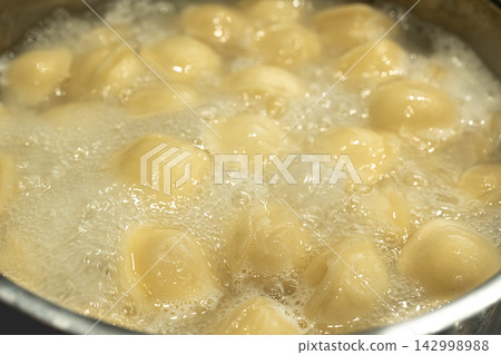 Cooking ravioli dumplings closeup Cooking ravioli dumplings closeup 142998988