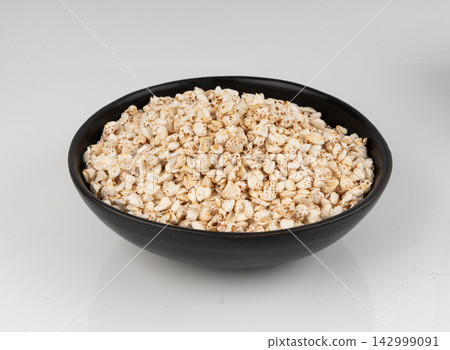Puffed buckwheat isolated, crispy cereal breakfast, ancient healthy food Puffed buckwheat isolated, crispy cereal breakfast, ancient healthy food 142999091