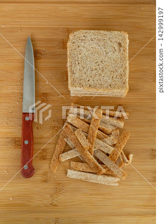 Cutting the crusts off, crustless bread for sandwiches closeup Cutting the crusts off, crustless bread for sandwiches closeup 142999197