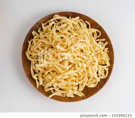 Passatelli spatzle pasta isolated, raw spaetzle noodles, dry homemade german macaroni Passatelli spatzle pasta isolated, raw spaetzle noodles, dry homemade german macaroni 142999235