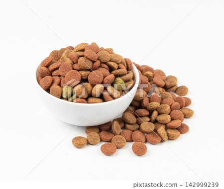 Dry pet food, dog color kibble pile, puppy meat and vegetable pellets, canine protein granules Dry pet food, dog color kibble pile, puppy meat and vegetable pellets, canine protein granules 142999239