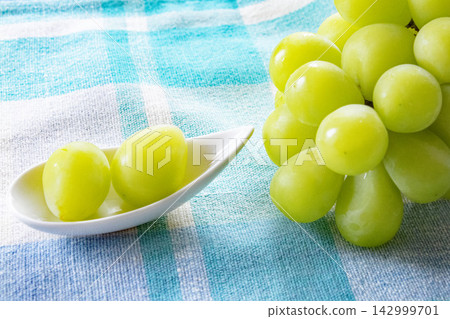 A close-up of delicious-looking Shine Muscat grapes. A close-up of delicious-looking Shine Muscat grapes. 142999701