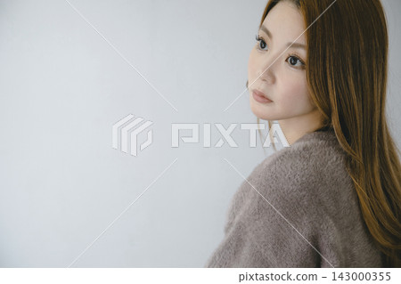 秋冬季節,一位美麗的日本女性穿著碎花連身裙,在室內拍攝的背影照。 秋冬季節,一位美麗的日本女性穿著碎花連身裙,在室內拍攝的背影照。 143000355