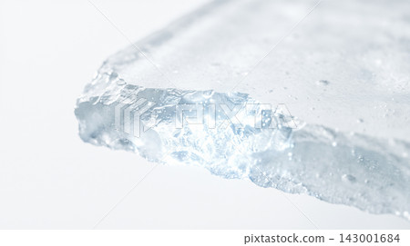 Chiseled ice cube corner, jagged frozen mineral piece, textured transparent glass fragment, rough fractured edge, studio shot, plain white background 143001684