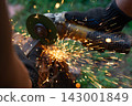 Man in protective gloves cutting metal with an angle grinder outdoors. Motion blur bright sparks flying. Concept of manual labour, home workshop, DIY metalwork and work safety. 143001849