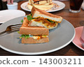 A cafe plate featuring a deliciously toasted sandwich. 143003211