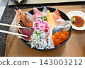 A colorful seafood bowl piled high with fresh seafood. 143003212