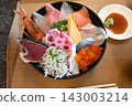 A luxurious seafood bowl topped with shrimp, sashimi, and whitebait. 143003214