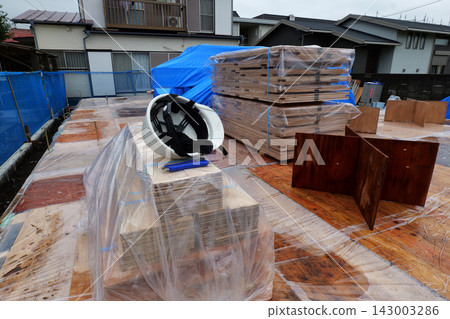 Unloading Building Materials at Construction Site Unloading Building Materials at Construction Site 143003286