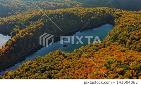 Biogradsko lake surrounded by mountains covered with bright autumn trees Biogradsko lake surrounded by mountains covered with bright autumn trees 143004068
