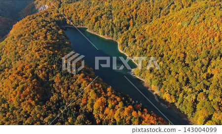 Biogradsko lake surrounded by mountains covered with bright autumn trees Biogradsko lake surrounded by mountains covered with bright autumn trees 143004099