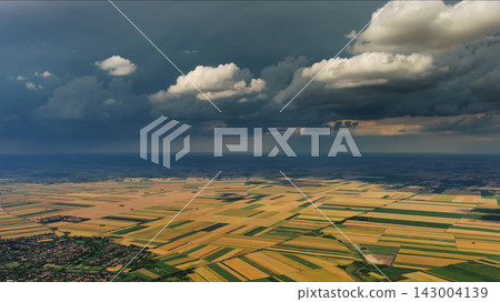Agricultural fields under dramatic dark storm clouds Agricultural fields under dramatic dark storm clouds 143004139