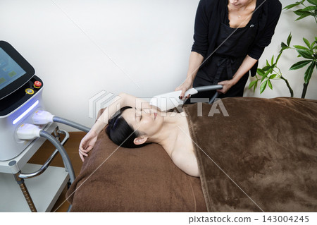 A woman removing hair from her armpits A woman removing hair from her armpits 143004245