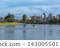 A water taxi operates on the Honkawa River under a clear blue sky. 143005501