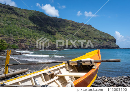 Traditional outrigger canoe on a rocky beach in Hiva Oa, Marquesas Islands Traditional outrigger canoe on a rocky beach in Hiva Oa, Marquesas Islands 143005590