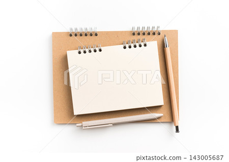 Top view of small blank spiral notebook stacked on kraft paper notebook Top view of small blank spiral notebook stacked on kraft paper notebook 143005687