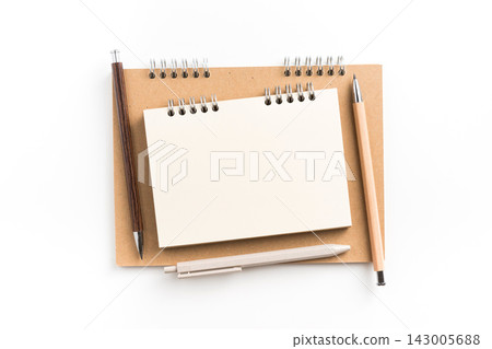 Top view of small blank spiral notebook stacked on kraft paper notebook Top view of small blank spiral notebook stacked on kraft paper notebook 143005688