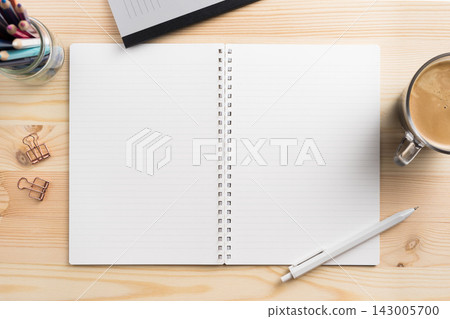 Top view of open lined spiral notebook mockup on light wooden desk Top view of open lined spiral notebook mockup on light wooden desk 143005700