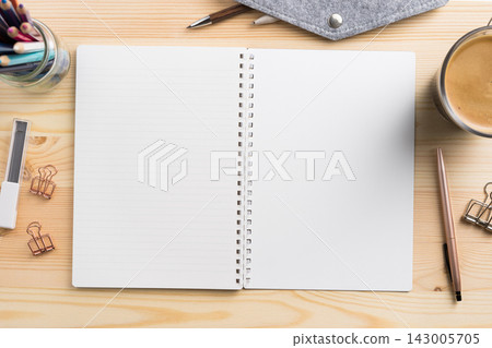 Top view of open lined spiral notebook mockup on light wooden desk Top view of open lined spiral notebook mockup on light wooden desk 143005705