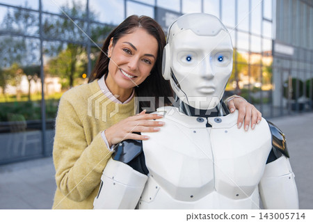 Happy female hugging shoulder of futuristic white robot Happy female hugging shoulder of futuristic white robot 143005714