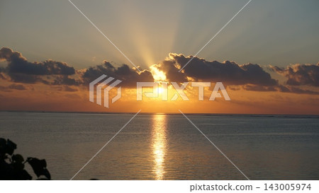 The rising sun casts majestic rays of light across the sea. The rising sun casts majestic rays of light across the sea. 143005974