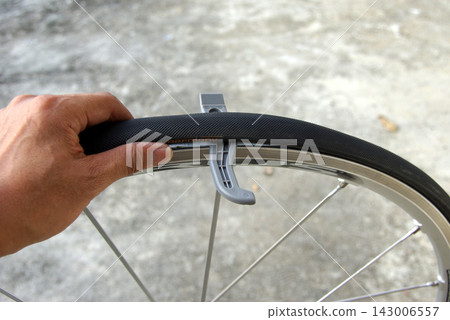 The process of removing a road bike tire from the rim. The process of removing a road bike tire from the rim. 143006557