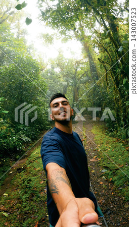 Man smiling taking selfie in Arenal Volcano National Park Man smiling taking selfie in Arenal Volcano National Park 143007523