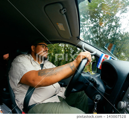 Man driving car during a road trip in Costa Rica Man driving car during a road trip in Costa Rica 143007528