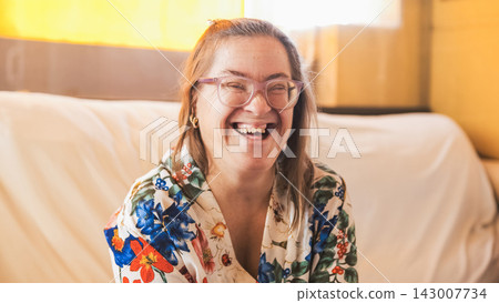 Happy woman with down syndrome laughing at home Happy woman with down syndrome laughing at home 143007734