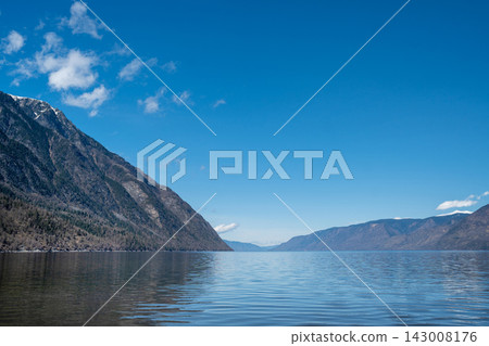 A tranquil and serene mountain lake showcasing beautiful reflections and ethereal mist A tranquil and serene mountain lake showcasing beautiful reflections and ethereal mist 143008176