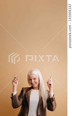 Happy senior woman pointing up blank space Happy senior woman pointing up blank space 143008187