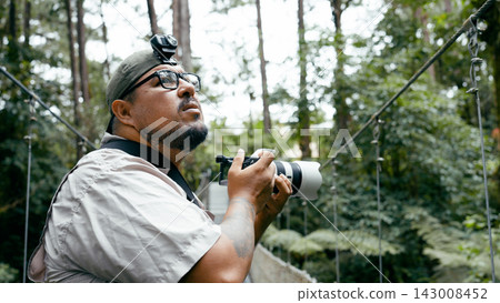 Man photographing nature on Arenal Volcano suspension bridge 143008452