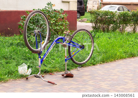 Bicycle standing upside down in backyard ready for examination and waiting for owner and mechanic. Broken bike repair 143008561