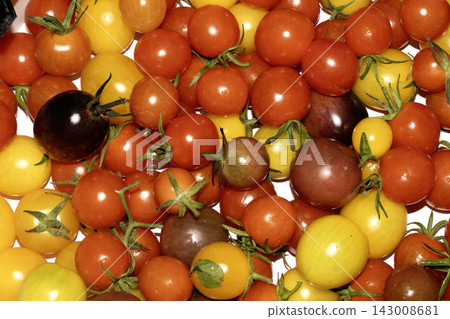 Mixed colour tomatoes on a white background plentiful harvest 143008681