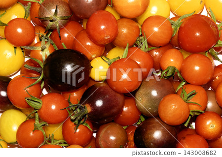 Mixed colour tomatoes on a white background plentiful harvest 143008682