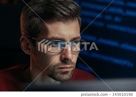 Close up of coder working with deep focus on data science project in dark Close up of coder working with deep focus on data science project in dark 143010198