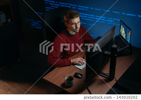 Programmer works late at night on a demanding data science and AI task. Programmer works late at night on a demanding data science and AI task. 143010202
