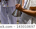 A woman dressed in a white dress 143010697