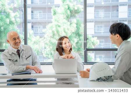 Men and women in work clothes having a meeting Men and women in work clothes having a meeting 143011433