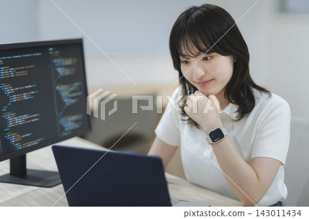 Female engineer working on a computer Female engineer working on a computer 143011434