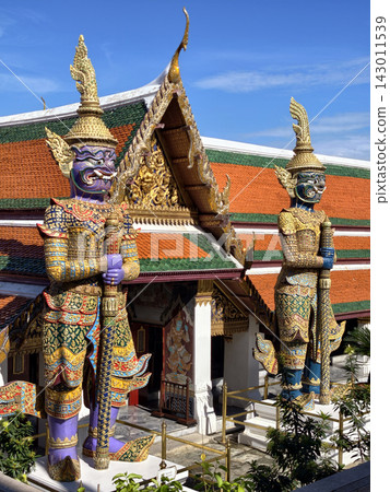 Two giant colorful yaksha guardian statues at temple entrance 143011539