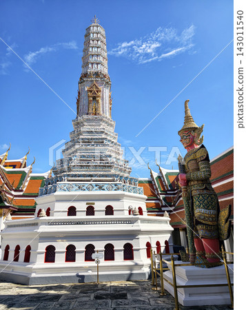 White temple pagoda with giant Yaksha guardian under blue sky White temple pagoda with giant Yaksha guardian under blue sky 143011540