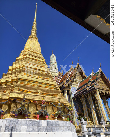 Golden pagoda with demon guardians at traditional Thai temple Golden pagoda with demon guardians at traditional Thai temple 143011541